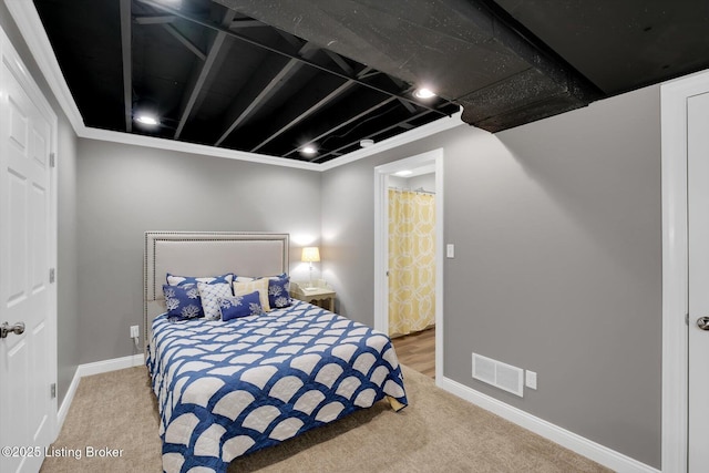 carpeted bedroom featuring baseboards and visible vents