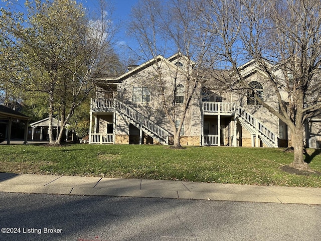 view of front of home featuring a front lawn and stairs