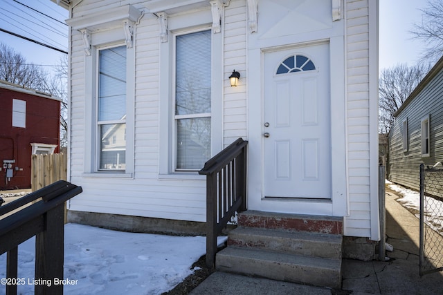 view of exterior entry featuring fence