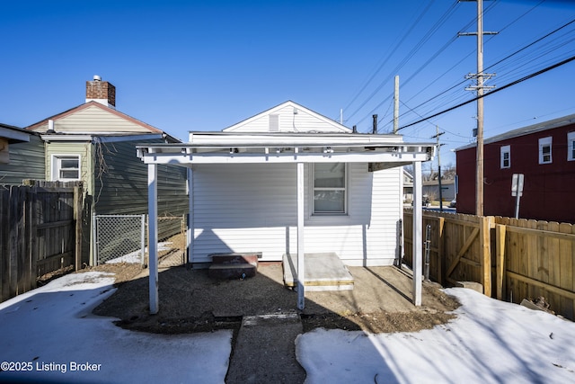 back of property featuring fence