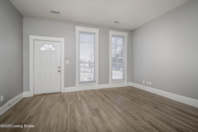 entrance foyer featuring wood finished floors, visible vents, and baseboards