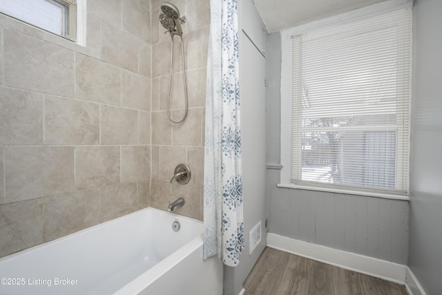 full bath featuring shower / bathtub combination with curtain, baseboards, and wood finished floors