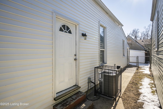 property entrance featuring cooling unit, a gate, and fence