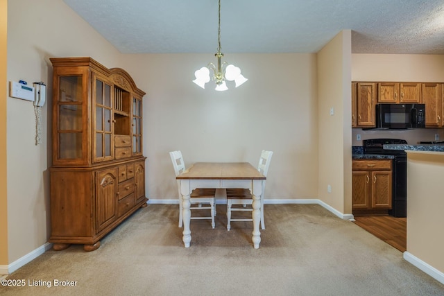 dining area with light colored carpet, a notable chandelier, a textured ceiling, and baseboards