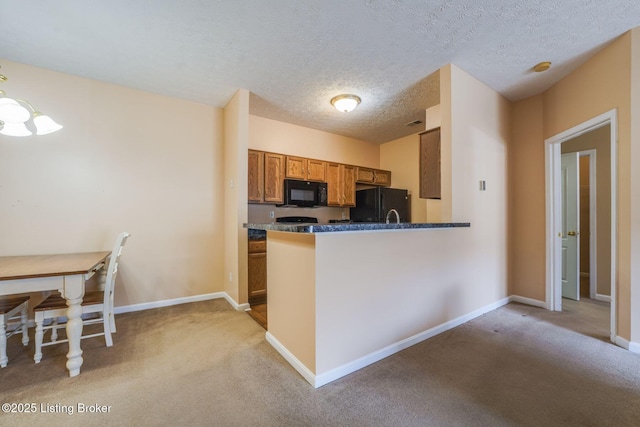 kitchen featuring black appliances, baseboards, brown cabinetry, and light colored carpet