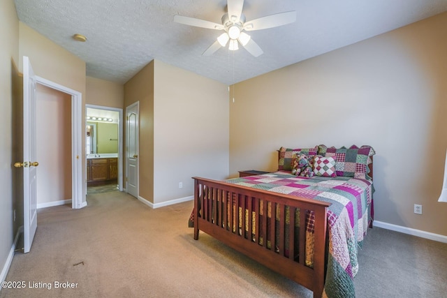 bedroom with carpet flooring, a textured ceiling, and baseboards