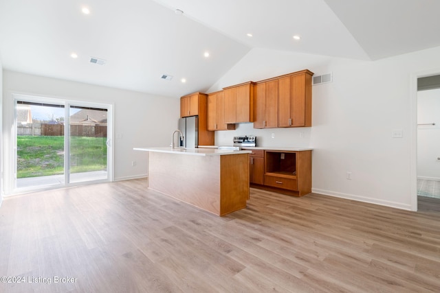 kitchen featuring visible vents, brown cabinetry, an island with sink, stainless steel appliances, and light countertops