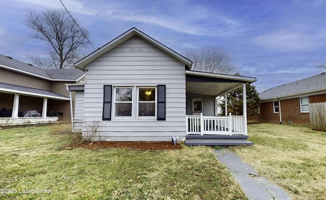 view of front of home with covered porch and a front lawn