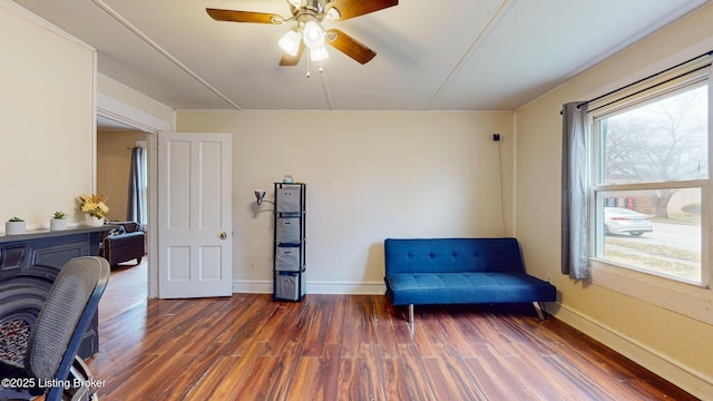 sitting room featuring ceiling fan, baseboards, and wood finished floors