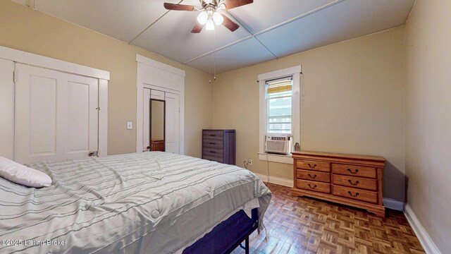 bedroom featuring cooling unit, a ceiling fan, and baseboards