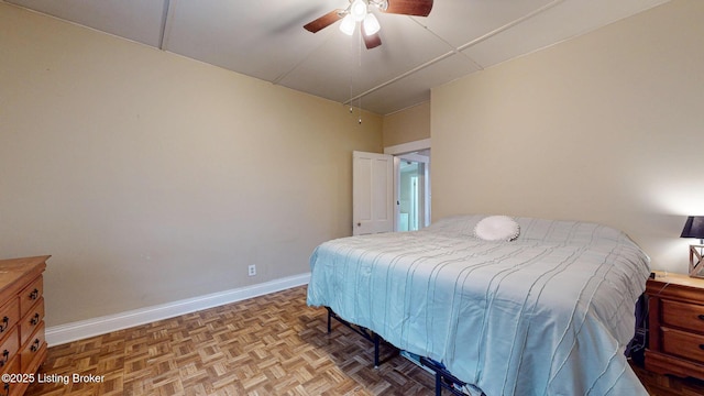 bedroom with a ceiling fan and baseboards