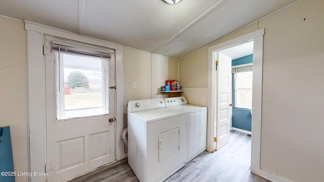 laundry area with laundry area, light wood-type flooring, and separate washer and dryer