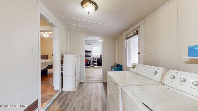 laundry area featuring light wood-style flooring and washer and clothes dryer