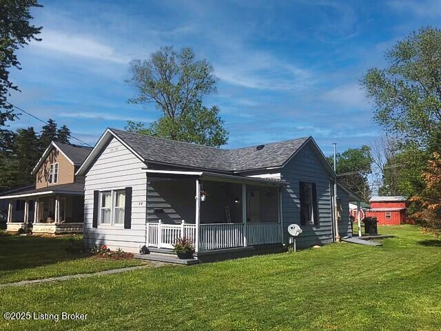 711 6th St, Carrollton, KY 41008 - view of front of house featuring a porch and a front yard