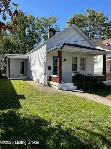 view of front of house featuring a porch, a chimney, and a front lawn