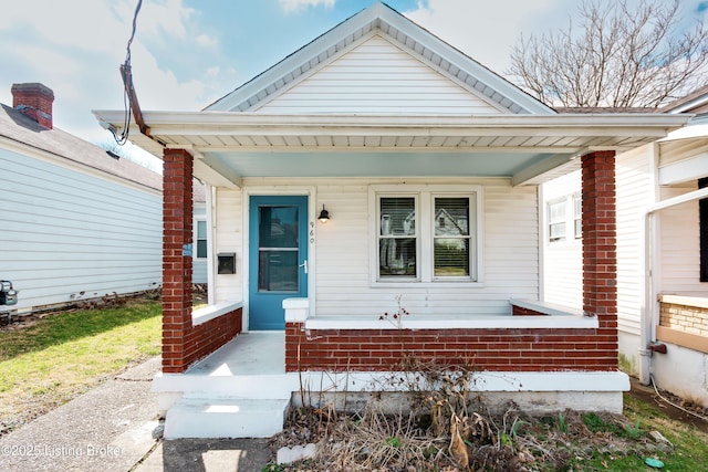 shotgun-style home featuring a porch