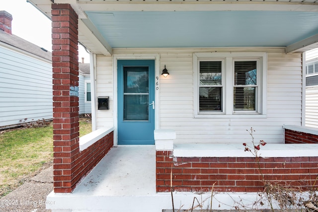 view of exterior entry with covered porch