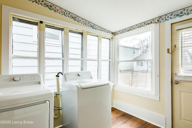 laundry area with laundry area, independent washer and dryer, baseboards, and wood finished floors