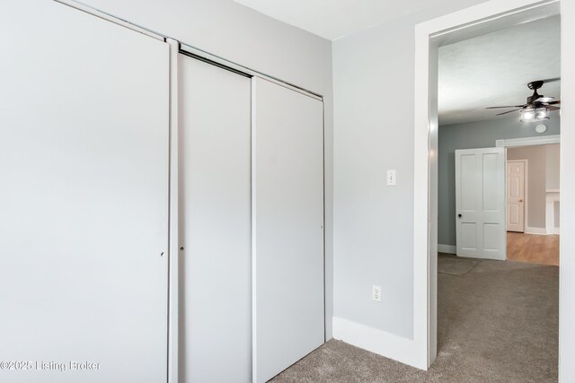 unfurnished bedroom with baseboards, a closet, and light colored carpet