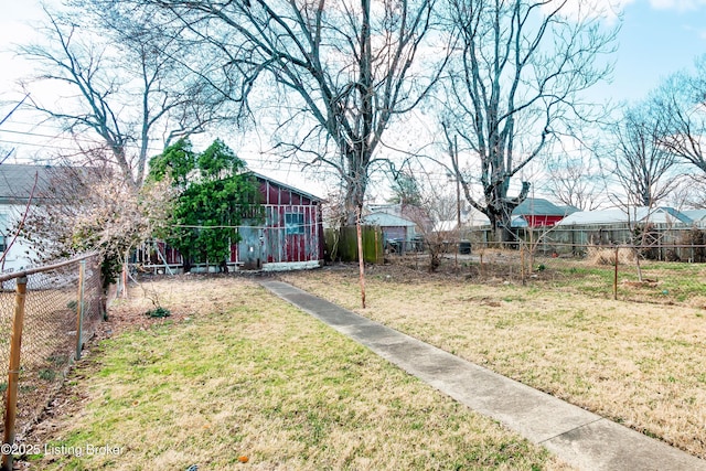 view of yard with a fenced backyard and an outbuilding