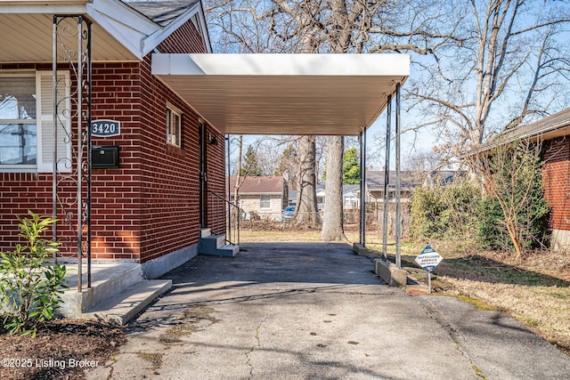 view of parking / parking lot with an attached carport and driveway