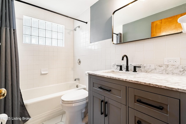 full bathroom featuring tile walls, toilet, shower / bath combination with curtain, vanity, and backsplash