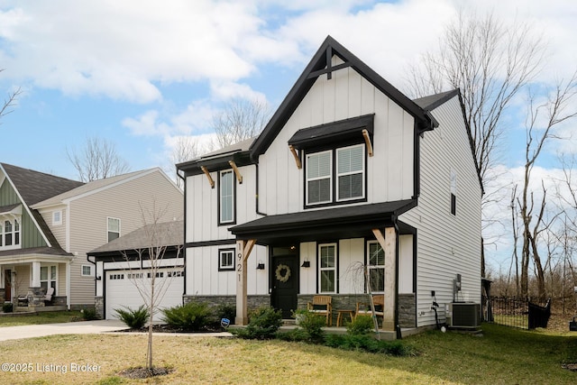 modern farmhouse featuring board and batten siding, a front yard, covered porch, and fence