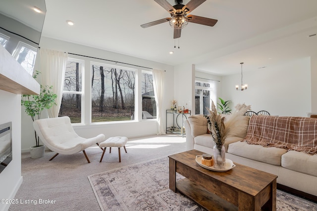 living area featuring ceiling fan with notable chandelier, carpet flooring, visible vents, and recessed lighting