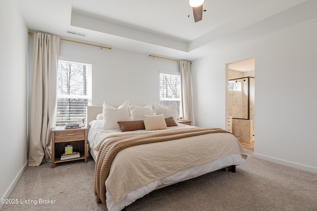 bedroom with baseboards, a raised ceiling, and carpet flooring