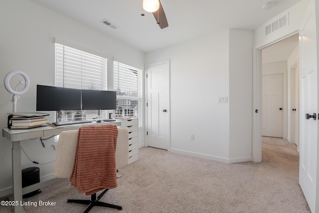 office area featuring baseboards, visible vents, ceiling fan, and carpet flooring