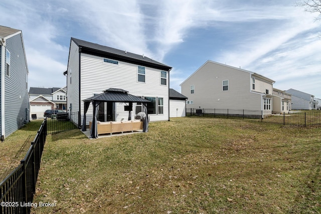 back of property featuring a fenced backyard, an outdoor hangout area, a lawn, and a gazebo