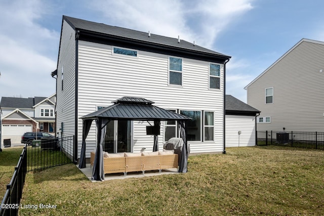 back of property featuring a gazebo, a lawn, outdoor lounge area, and a fenced backyard