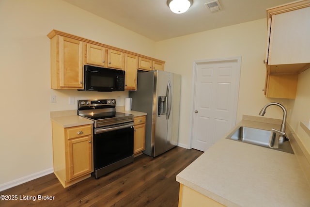 kitchen with dark wood-style floors, visible vents, appliances with stainless steel finishes, and a sink