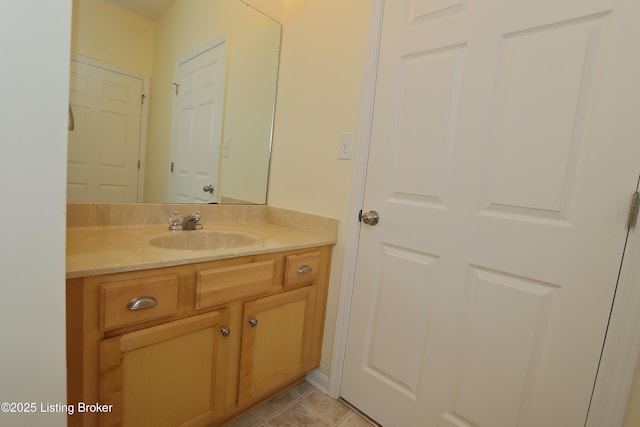 bathroom featuring tile patterned flooring and vanity