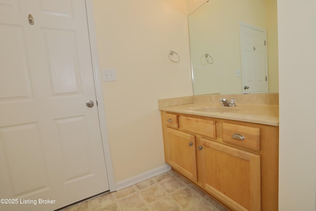 bathroom with tile patterned flooring, vanity, and baseboards