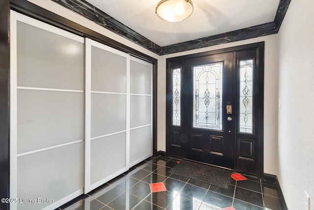 entrance foyer with dark tile patterned flooring