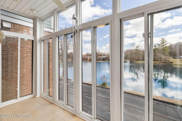 unfurnished sunroom with a water view and a wealth of natural light