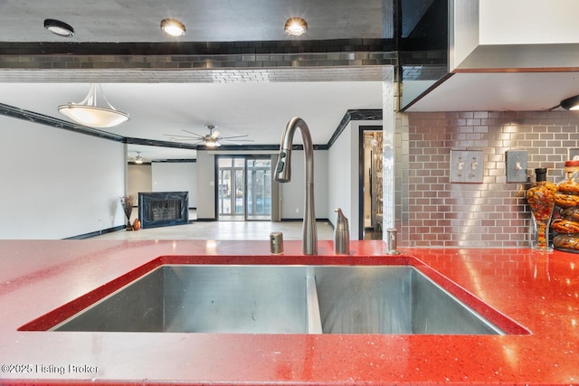 kitchen featuring ceiling fan and a sink