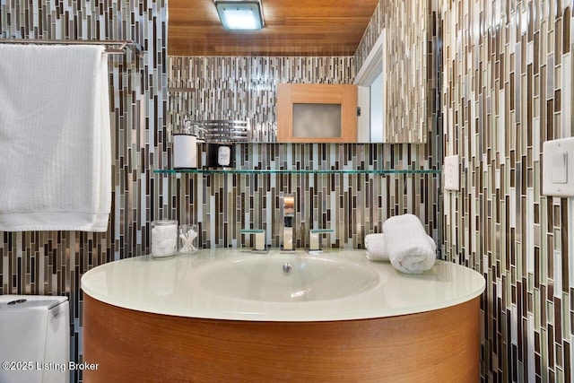 bathroom with wood ceiling, backsplash, and tile walls