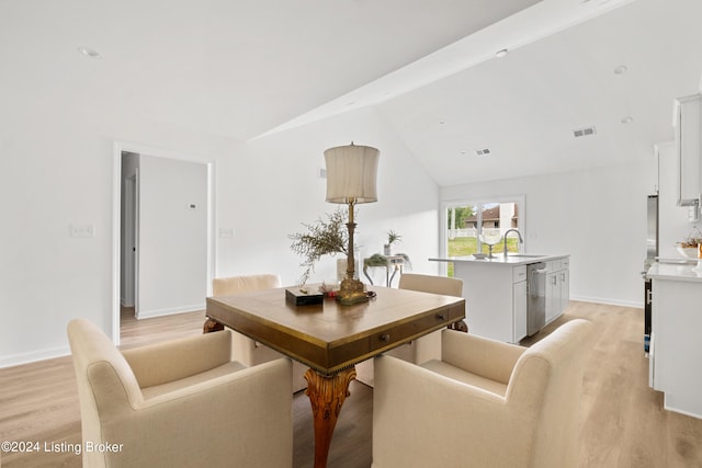 dining room with light wood-style flooring, visible vents, lofted ceiling with beams, and baseboards