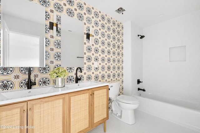 bathroom with double vanity, a sink, toilet, and tile patterned floors