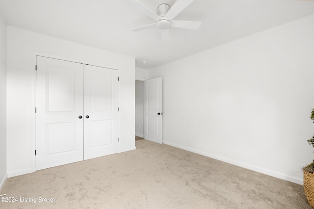 unfurnished bedroom with a closet, carpet flooring, and baseboards