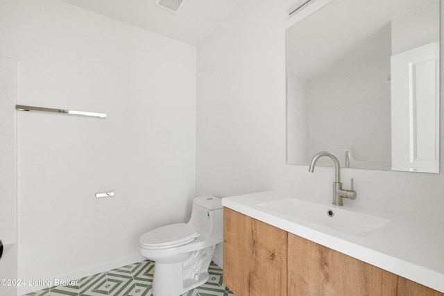 bathroom featuring visible vents, vanity, and toilet