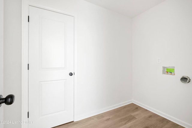 laundry room with laundry area, hookup for a washing machine, light wood-style flooring, and baseboards