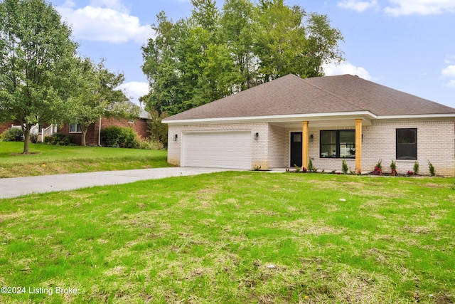 view of front of property featuring a garage, driveway, brick siding, and a front lawn