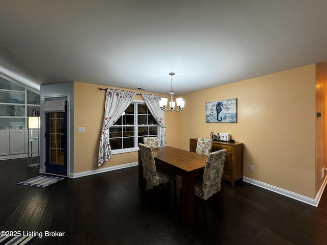 dining space featuring baseboards, built in shelves, dark wood finished floors, and a notable chandelier