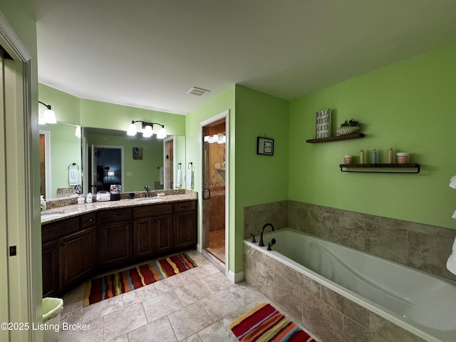 full bath with a garden tub, double vanity, visible vents, a sink, and a shower stall