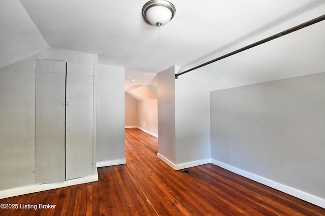 bonus room featuring lofted ceiling, baseboards, and hardwood / wood-style flooring