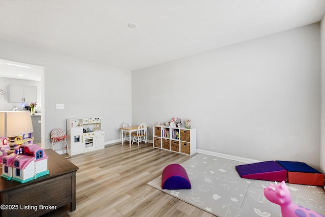 rec room featuring wood finished floors and baseboards