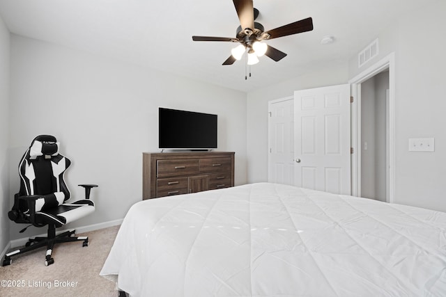 carpeted bedroom featuring a ceiling fan, visible vents, and baseboards